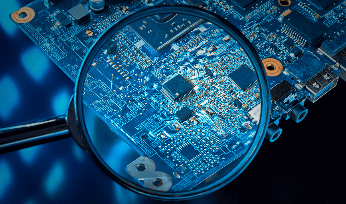 Magnifying glass over a semiconductor chip.