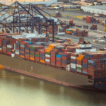 Container Ship Docked at Sea Port with Cargo at sunset