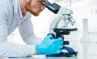 Man looking through microscope