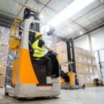 Workers using forklifts to move products in a Vietnam bonded warehouse