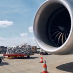 Cargo packaged for air transport next to airplane