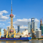 A container ship sailing along the Shanghai skyline, representing Shanghai to Southeast Asia shipping and the city’s role as a global logistics hub.