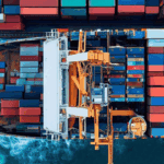 Overhead view of a container ship loaded with cargo, symbolizing how tariffs and trade policy changes are driving a shift in global freight strategy