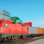 Freight train at intermodal container terminal illustrating multimodal transport logistics and seamless cargo transition