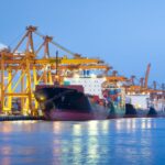 Container ships docked at a major Asian seaport with cranes loading cargo, representing ocean freight forwarding and Asia trade lanes supported by Dimerco.