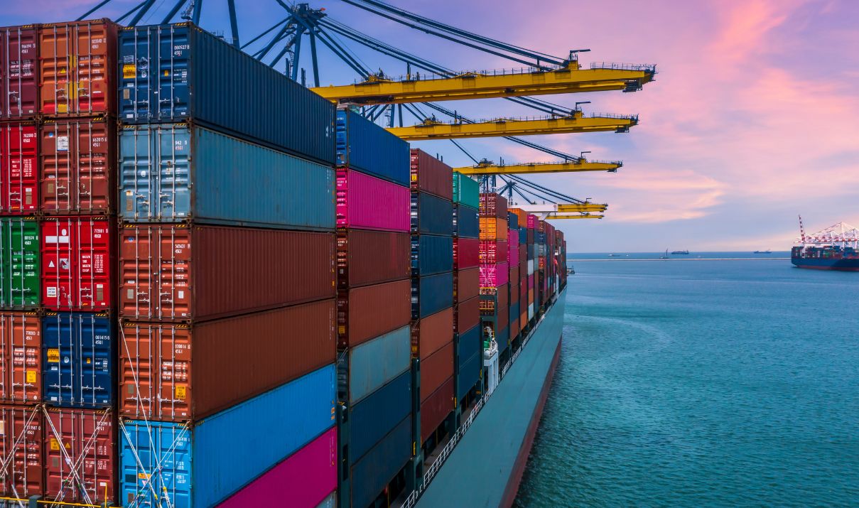 Container ship loaded with cargo at a busy port during contracting season, reflecting transpacific freight activity in 2026.