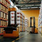 Vendor Managed Inventory warehouse showing automated forklifts and high-density storage racks in a semiconductor distribution center
