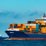 Container ship carrying stacked cargo at sea, representing global shipping activity in the Ocean Freight Outlook 2026