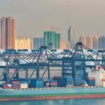 Container ship at port representing shipping from Hong Kong to the US via ocean freight