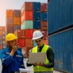 Logistics workers inspecting cargo containers at port using laptop, supporting BIS Certification compliance and customs clearance in India