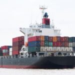 Ocean freight forwarder vs carrier comparison showing container ship used in global shipping logistics