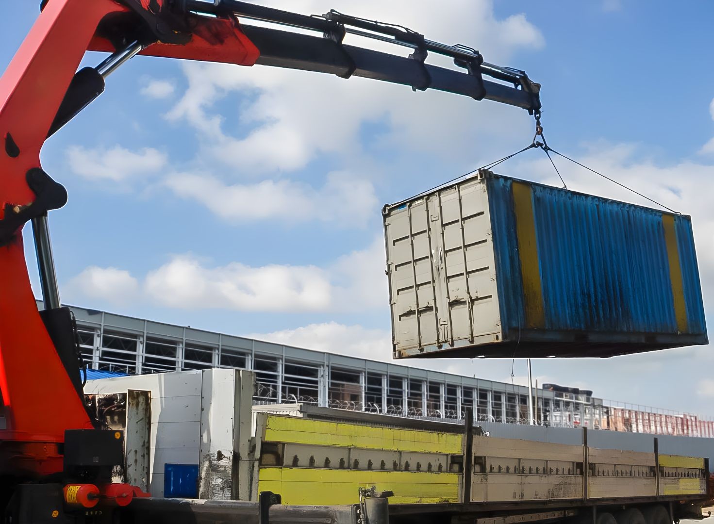 The container is being loaded onto the truck.