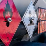 Shipping dangerous goods placards and hazard labels displayed on an international cargo tanker for dangerous goods transportation compliance