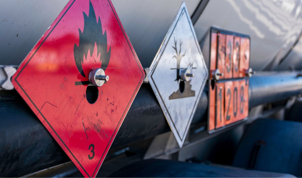 Shipping dangerous goods placards and hazard labels displayed on an international cargo tanker for dangerous goods transportation compliance
