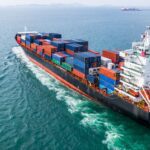 Cargo container ship transporting goods internationally, illustrating strategies to reduce import costs and MPF fees