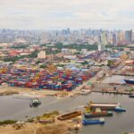 Shipping from the Philippines through the Port of Manila with container terminals, cargo vessels, and the Manila skyline