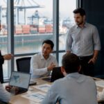 International freight forwarder team discussing logistics operations at a container port