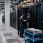 AI data center logistics with server racks, palletized equipment and a technician inside a modern data center